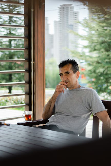 Person in a relaxed meditation pose on a balcony